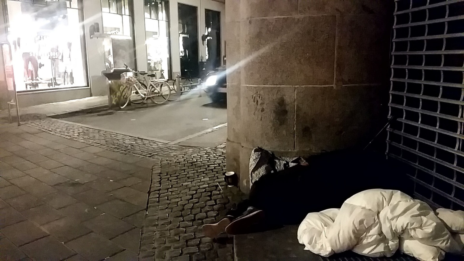 Homeless sleeping in a corner of the street